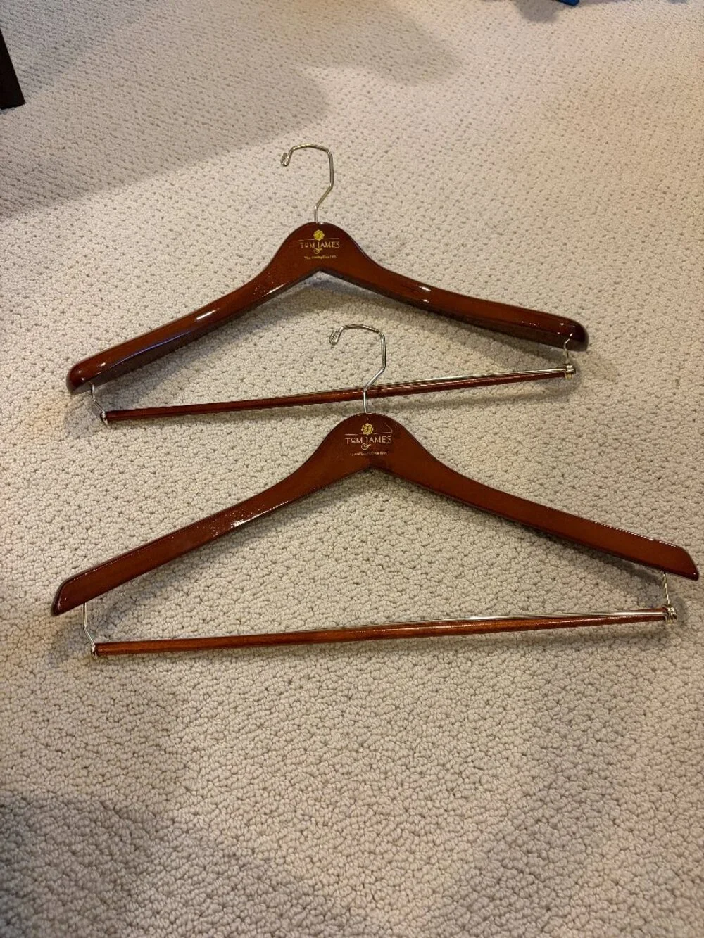 Tom James Wooden Suit Hangers with Bar set of 2, one is thicker than the other.